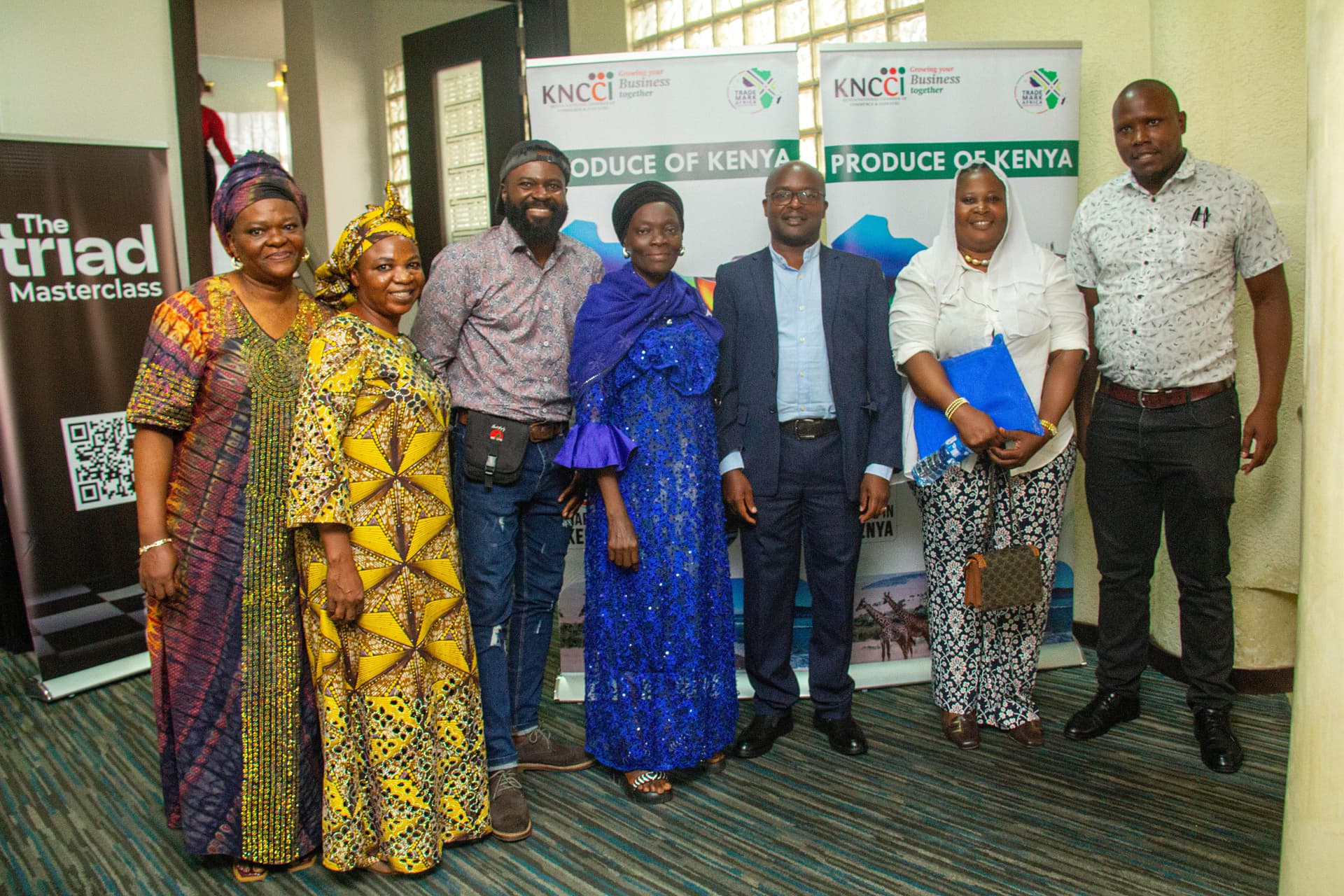 Delegates in front of Produce of Kenya banners